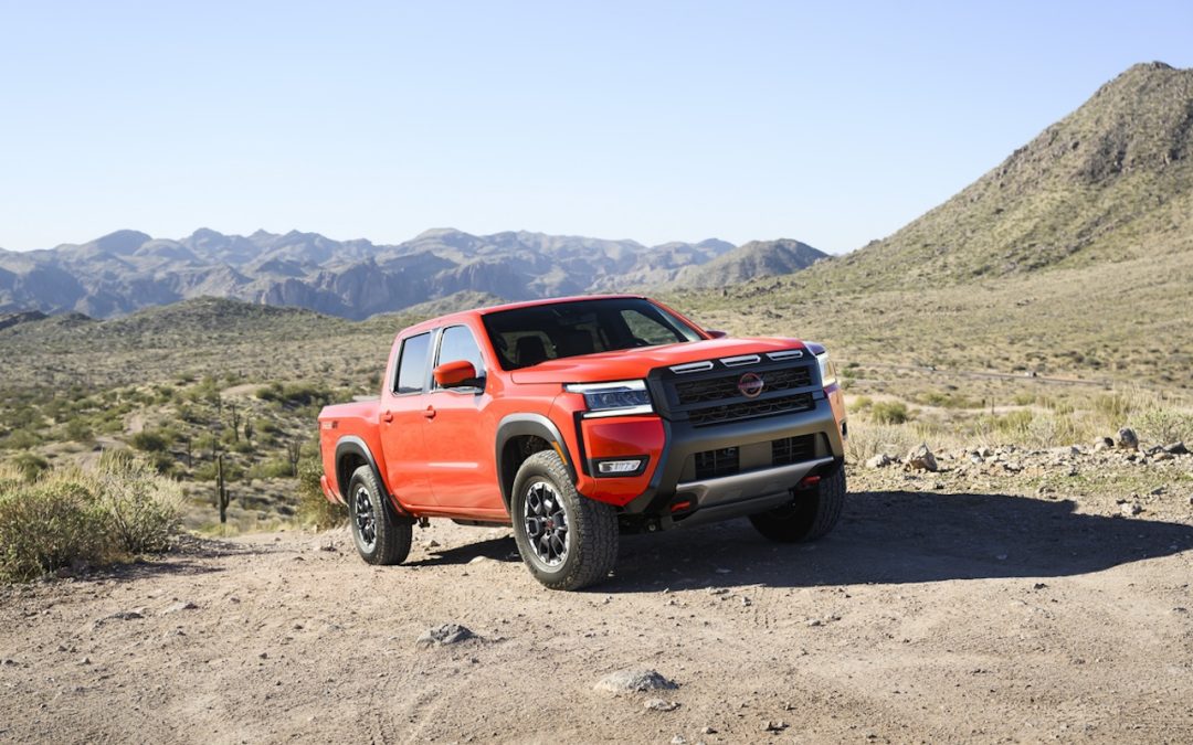 Red Nissan Frontier PRO-4X parked on a rocky mountain trail