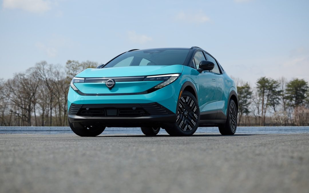 Blue Nissan electric SUV displayed from the front on an open paved surface